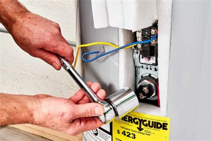 How do you remove a heating element from a water heater?