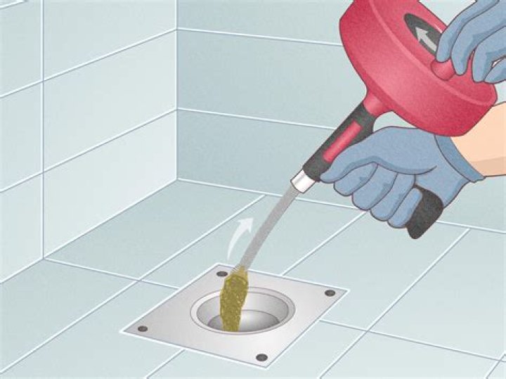 How do you use a manual drain snake?